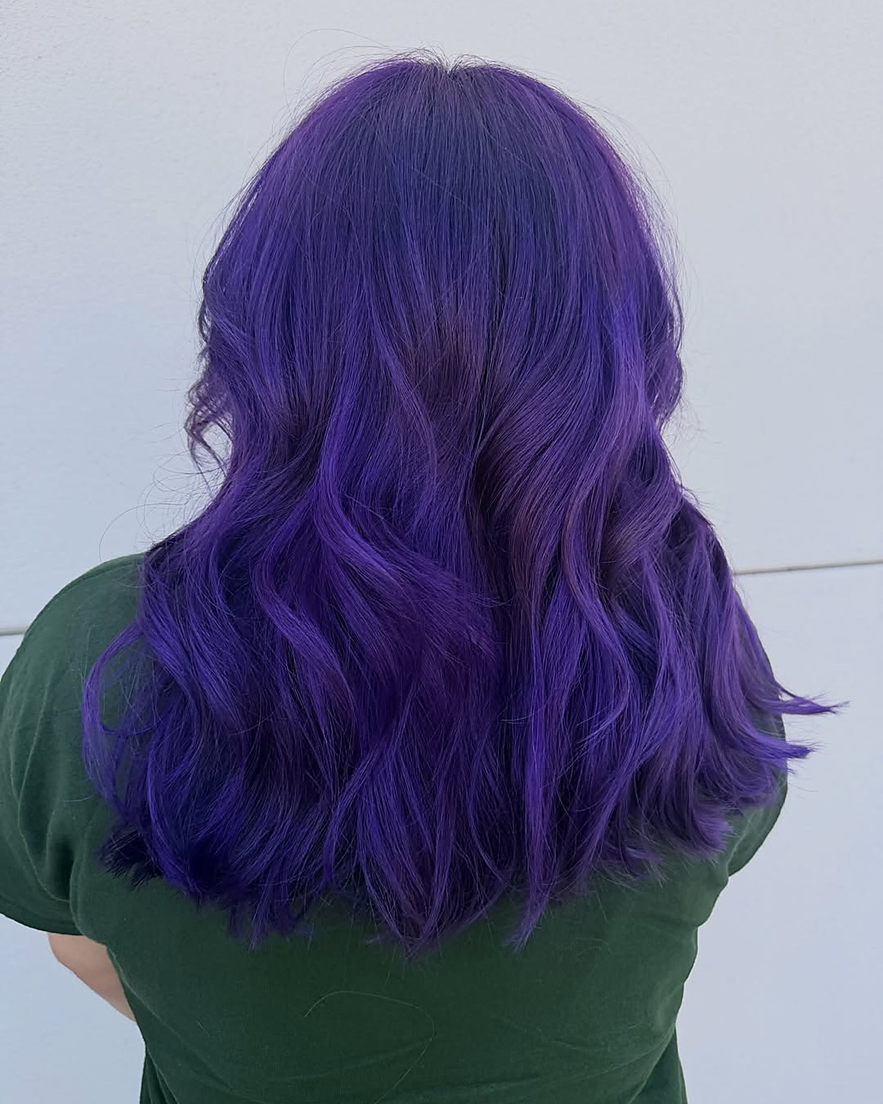Electric violet — all-over vivid violet on shoulder-length waves