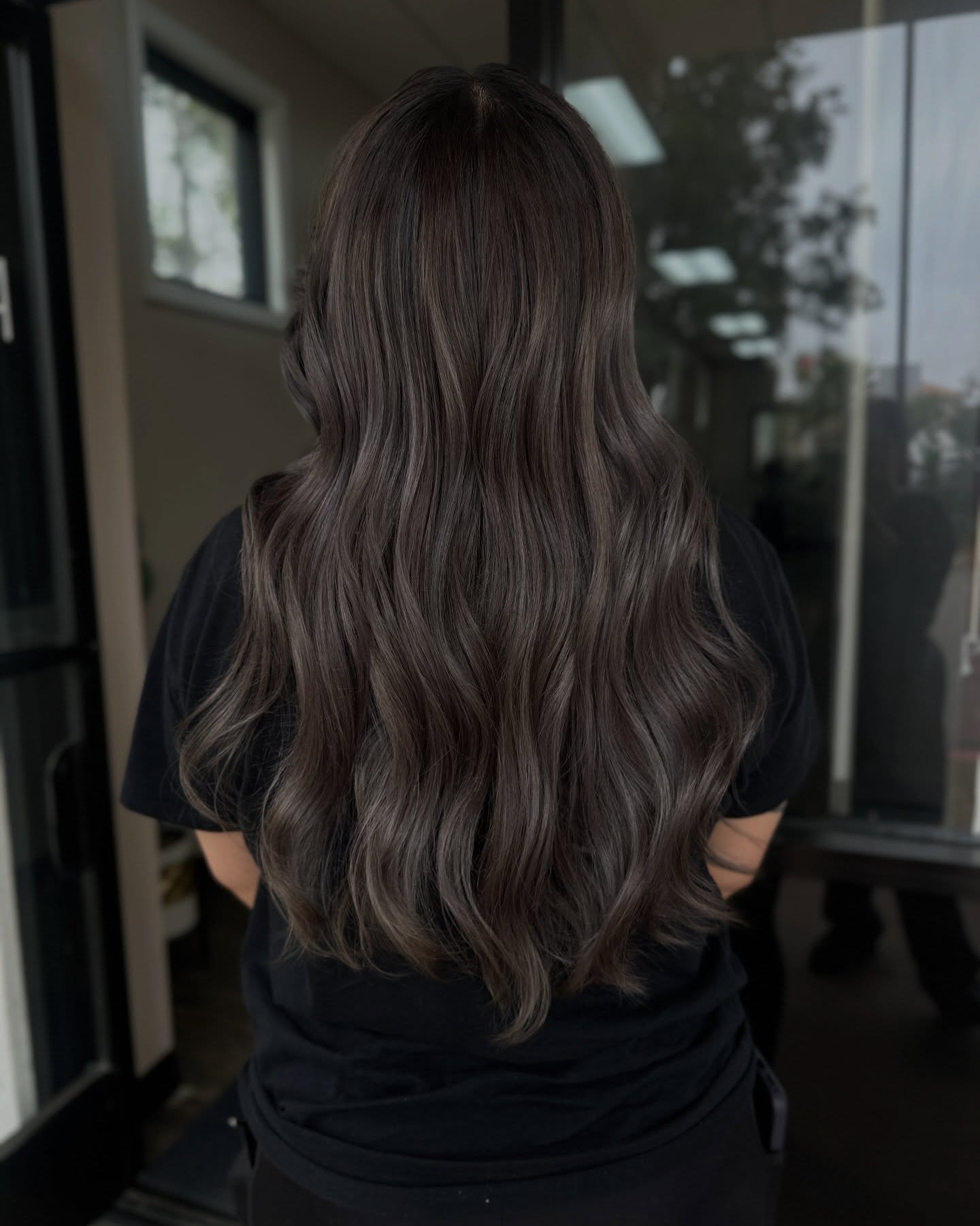 Ash ribbons — cool ash lightening ribboned through a glossy brunette